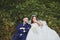 Wedding photo of a loving Kazakh Asian couple in nature, a beautiful bride in a white dress and veil, and a groom in a suit hug an