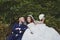 Wedding photo of a loving Kazakh Asian couple in nature, a beautiful bride in a white dress and veil, and a groom in a suit hug an