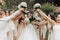 Wedding photo in nature. A brunette bride in a long white dress stands in front of her