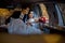 Wedding portrait. Happy young stylishly dressed couple is sitting in the car and looking through window. The bride with