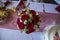A wedding posy with red roses and white flowers
