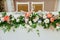 Wedding presidium. Big, long composition from fresh flowers and glass candlesticks.