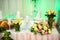Wedding presidium table with pink tablecloth, floral arrangement