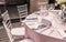 Wedding reception dinner. Round table served with flowers, serving silver. Holiday banquet menu. Decor of the interior of the