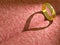 Wedding ring casting a heart on pink cloth