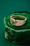 Wedding ring with emerald green gemstone on green velvet jewelry box