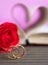 Wedding ring with pages of book curved heart shape with red rose