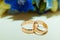 Wedding ring. Two gold vintage rings of the bride and groom are on the white table