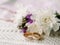 Wedding rings/band with floral decorations, on vintage knitted napkin, two golden rings. Country wedding in retro style