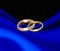 Wedding rings on blue drapery