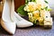 Wedding rings with bouquet and high heel shoes