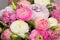 Wedding rings on bouquet of white and pink peonies