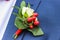 Wedding rings on boutonniere on lapel of jacket of groom.