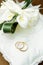 Wedding rings with calla bouquet on bridal pillow