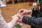 wedding rings and hands of bride and groom ring exchange couple at ceremony in love