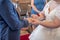wedding rings and hands of bride and groom ring exchange couple at ceremony in love