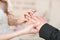 Wedding rings and hands of bride and groom. young wedding couple at ceremony. matrimony. man and woman in love. two