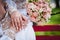 Wedding rings on the hands of the newlyweds. Golden rings on the hands of a guy and a girl