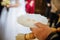 Wedding rings on plate at hand of priest at wedding ceremony at