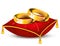 Wedding rings on red satin pillow