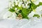 Wedding rings on satin pillow with trilliums