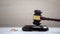 Wedding rings on table, gavel standing on sound block, divorce procedure, court