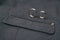 Wedding rings on textile grey suit textile tweed background