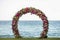 Wedding round arch decorated with beautiful colorful orchid and rose flowers