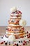Wedding rustic naked cake with flowers on wooden background