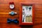 Wedding set of men`s stylish watch and bow-tie on a brown wooden background with golden rings and postcard in rustic