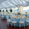 Wedding setup blue covered round tables in a pristine pavilion