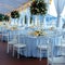 Wedding setup blue covered round tables in a pristine pavilion