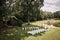 wedding site with white long chairs in the garden