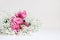 Wedding styled stock photo. Still life with pink roses and baby`s breath Gypsophila flowers on white table background