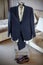 Wedding suit, shirt, trousers, shoes of groom hanging on hanger