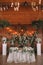 Wedding table banquet decorated with flowers and plants, retro lamps on a wooden background