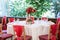 Wedding table decorated with red coloured chairs