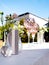 Wedding table setting decorated with fresh flowers in a vase, champagne coolers, and decorative glasses.