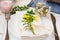 Wedding table setting, elegant, white yellow flowers, green leaves, candle, plates, blue napkin, wood table, outdoors, kinfolk, r