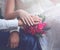 Wedding tender couple, hands of the bride and groom, pink gentle bouquet flowers