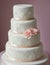 Wedding Theme, Finely detailed multi-tiered intricate wedding cake, detailed shapes decoration with pink roses