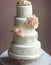 Wedding Theme, Modern style high detailed multi-tiered wedding cake intricate motif with white and soft peach color rose