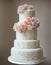 Wedding Theme, Modern style multi-tiered wedding cake with soft intricate designs and multi colored roses