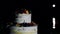 Wedding three-tiered cake white decorated with fruits