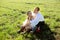 Wedding in village, groom and bride have a fun on a field grass