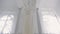 Wedding white dress hanging on chandelier inside space room