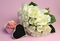 Wedding white roses bouquet with pink cupcake and blank heart sign.