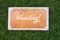 Wedding wooden sign on the grass. Spring or summer
