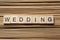 WEDDING word written on wood block at wooden background