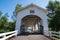 The Weddle Bridge, a white covered bridge near Sweet Home, Oregon, spans Ames Creek